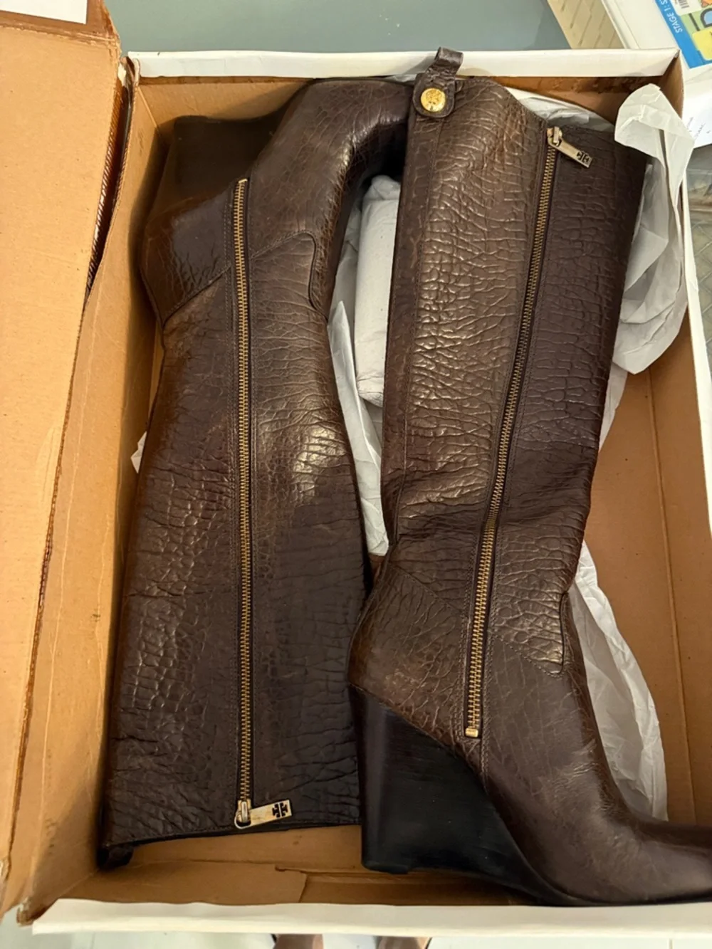 Tall brown leather boots in a box